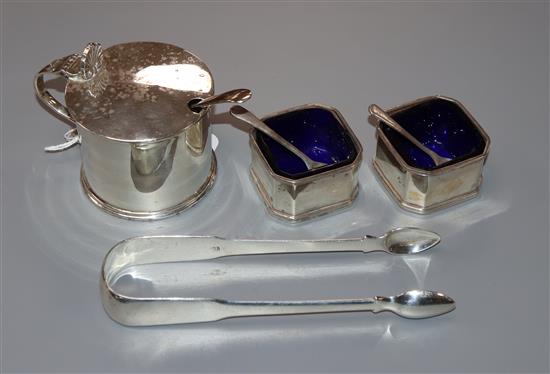 A silver drum mustard, a pair of Georgian silver fiddle pattern sugar tongs and a pair of silver salts.